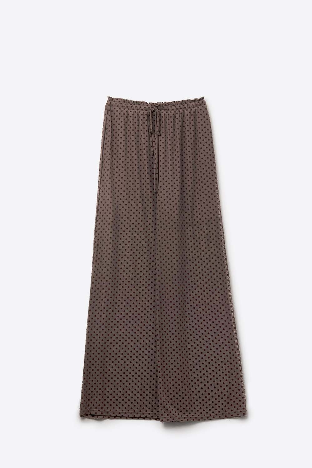 Elegantes pantalones marrones de lunares transparentes con bolsillos laterales