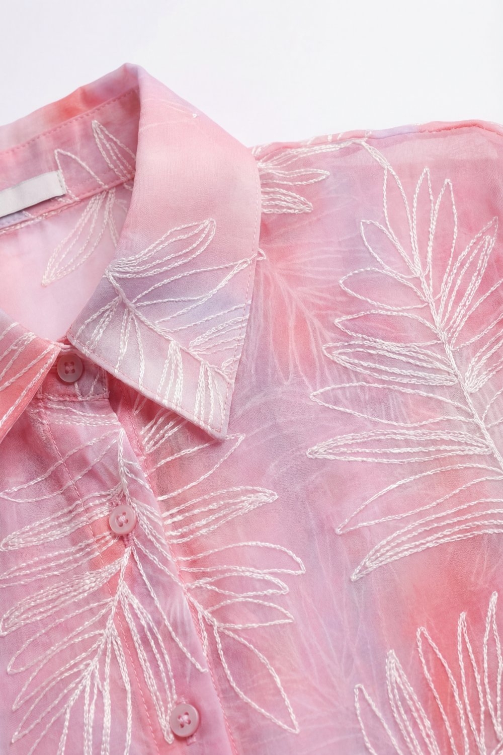 Camisa abotonada con estampado de hojas rosa y tela transl&uacute;cida