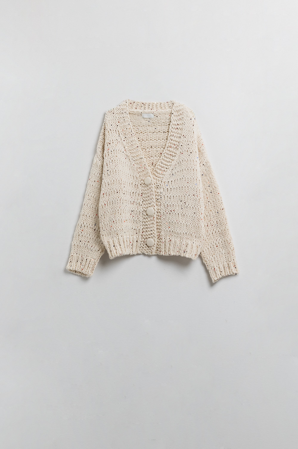 Chaqueta oversize de punto grueso en color crema con detalle de lentejuelas